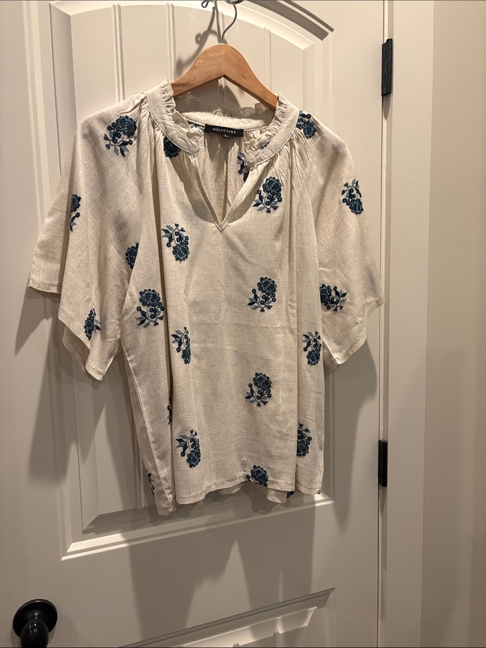Solitaire Cream Split-Neck blouse with Blue Floral Embroidery